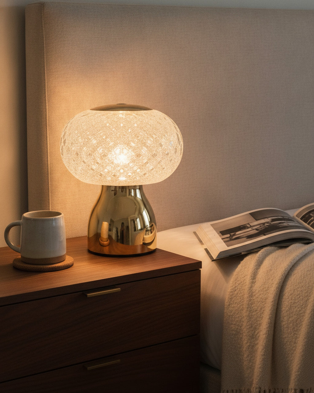 Brilliance faceted crystal sphere table lamp glowing on a bedside table in an upscale bedroom