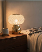 Brilliance faceted crystal sphere table lamp glowing on a bedside table in an upscale bedroom