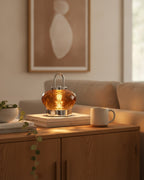 Amber faceted crystal lamp on an oak sideboard with art books