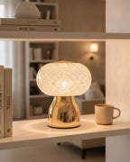Brilliance crystal sphere ambient lamp glowing warmly on an open wooden bookshelf