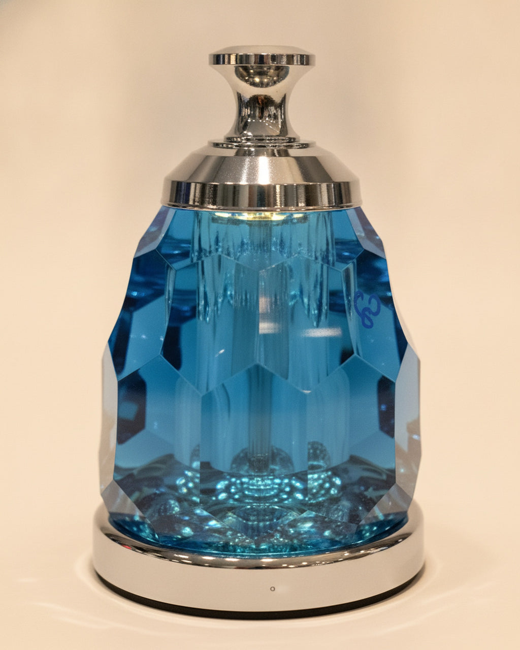 Close-up of the faceted blue K9 crystal body, polished aluminum cap and base