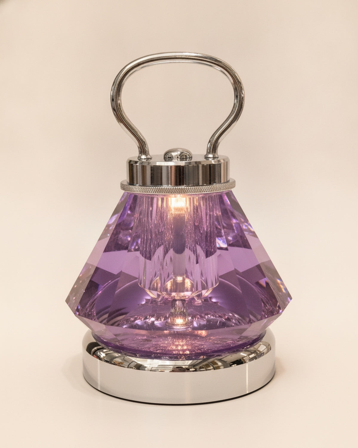 Close-up of the faceted purple K9 crystal body, polished chrome handle and collar