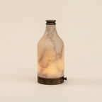 Translucent alabaster body and antique-bronze aluminium base of the Admire lamp
