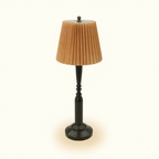 Jovial pleated fabric table lamp, brown shade, on warm cream background
