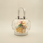 Nivin iridescent crystal lantern standing upright on a warm cream background